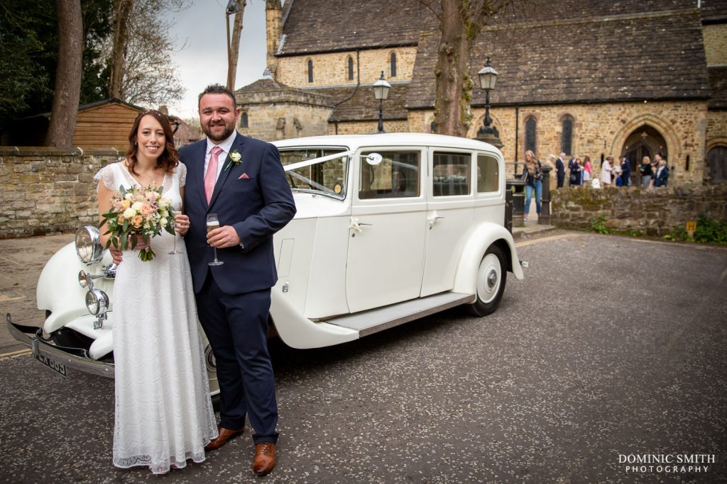 Bride and Groom with car
