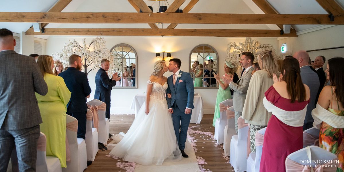 Walking Down the Aisle at Cottesmore Hotel, Golf and Country Club, Sussex