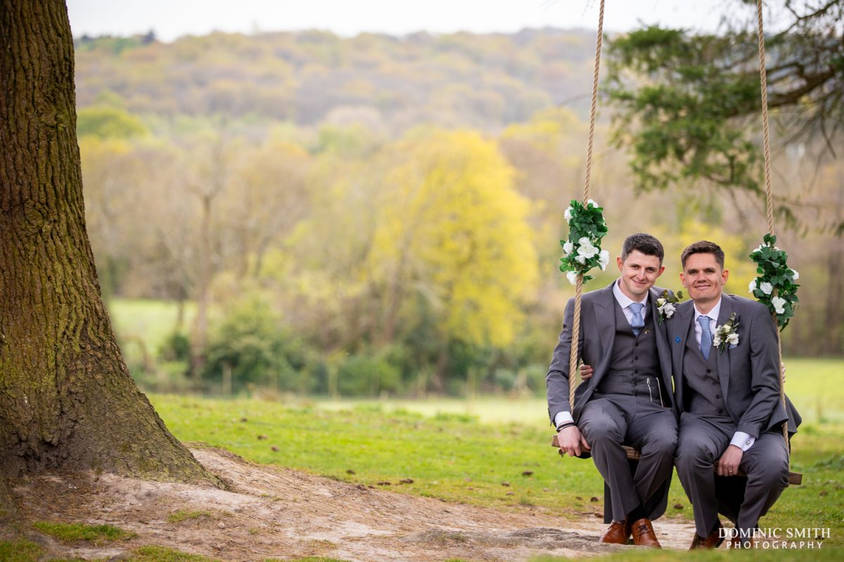 Grooms sitting on Highley's swing