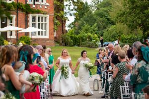 Brides walking down the aisle together at Highley Manor