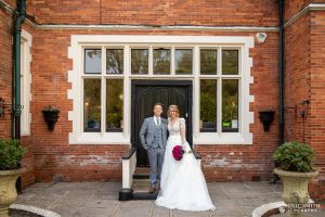 Wedding Couple outside the main doors of Highley Manor