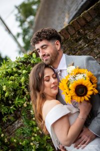 Wedding Couple Photography with Sunflowers at Bysshe Court Barn