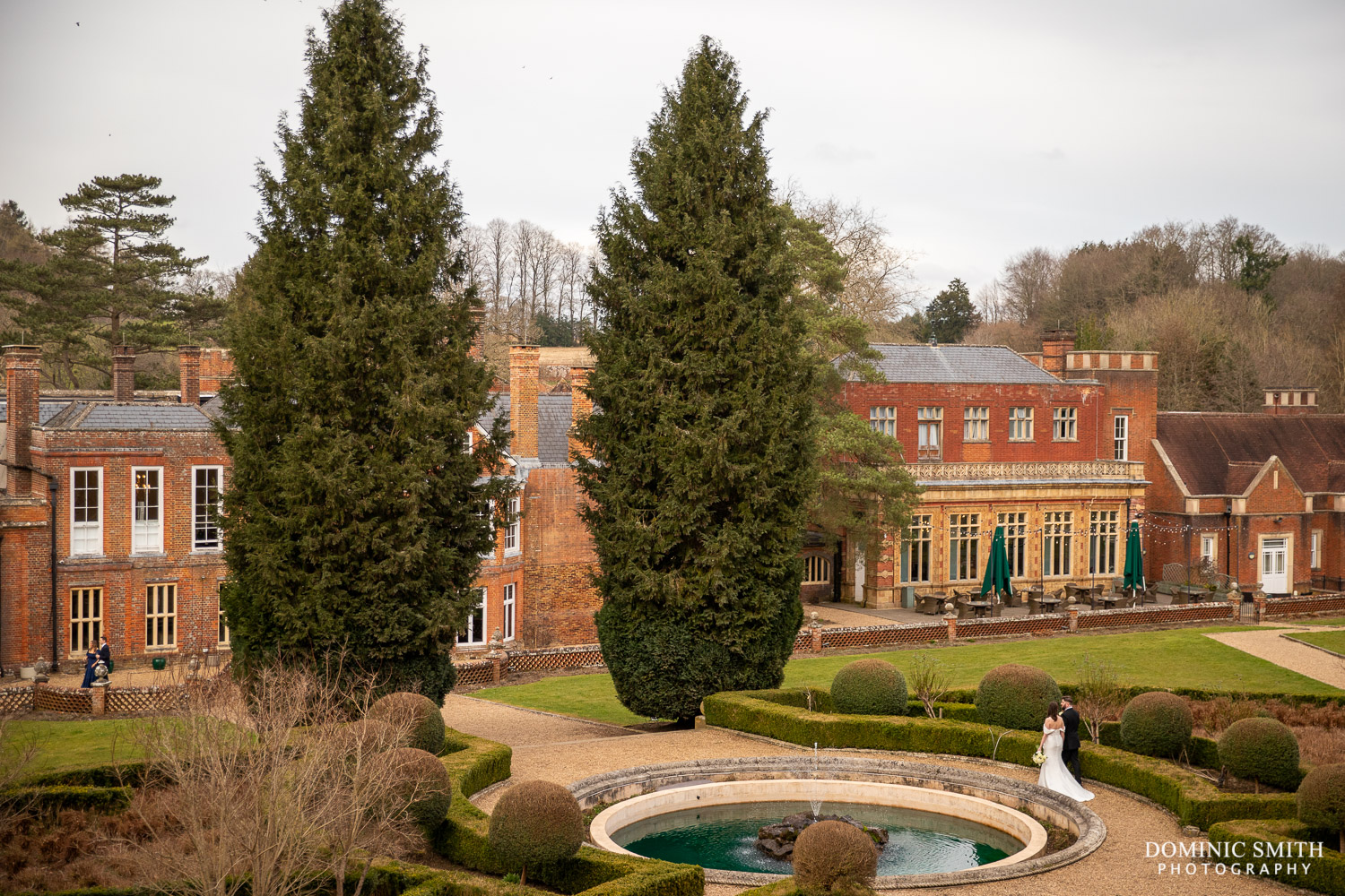 Bride and Groom walking through Wotton House Gardens