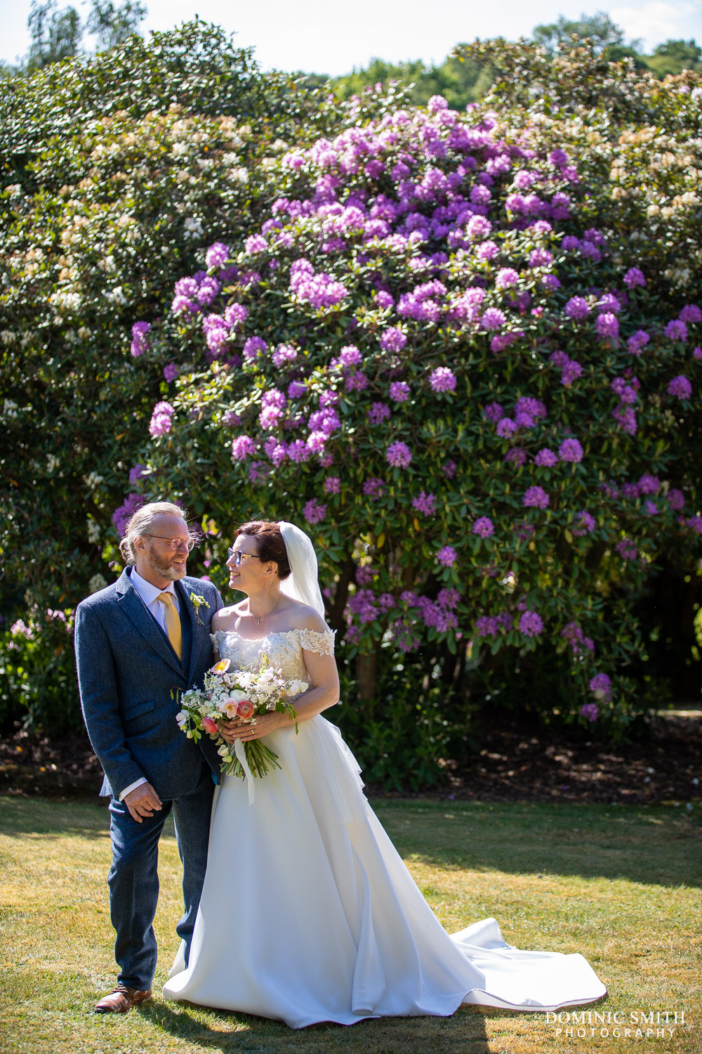 Bride and Groom in front of the Rhododendrons at The Spa Hotel in Tunbridge Wells