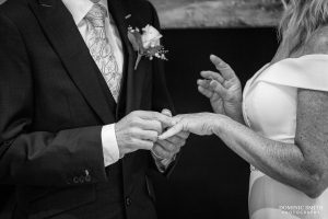 Black and White photograph of wedding ring exchange at Wingrove House