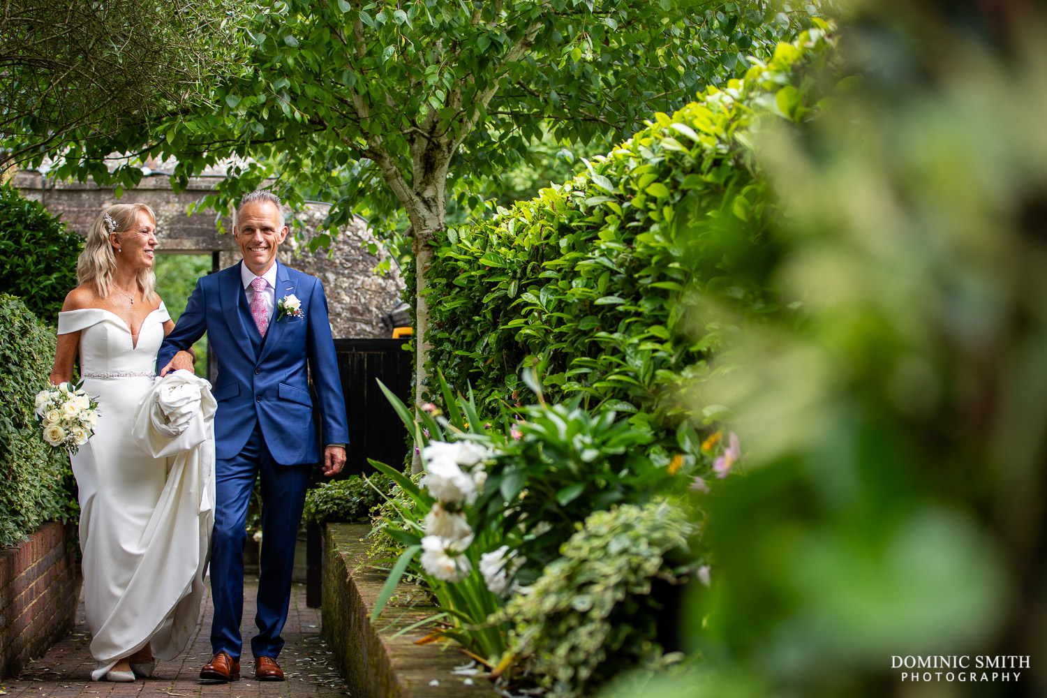 Bride and Groom walking through the Wingrove House Gardens