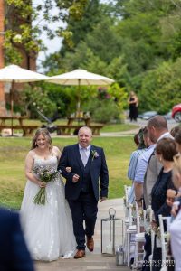 Bride walking down the aisle on her wedding day at Highley Manor
