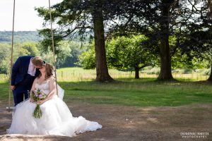 Bride and Groom on the swing at Highley Manor