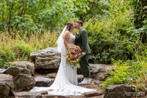 Two brides share a kiss at Claremont Gardens