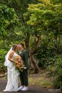 Brides sharing a kiss in Claremont Gardens outside Glenmore House
