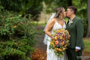 Brides sharing a kiss in Claremont Gardens in Surbiton