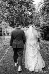 Black and white photo as the brides walk away together