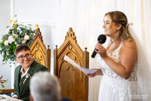 Bride gives her speech as her wife looks on