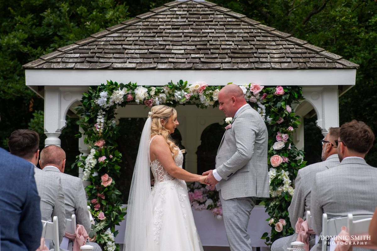 Bride and Groom during an outside wedding ceremony at Cottesmore Hotel and Golf Club