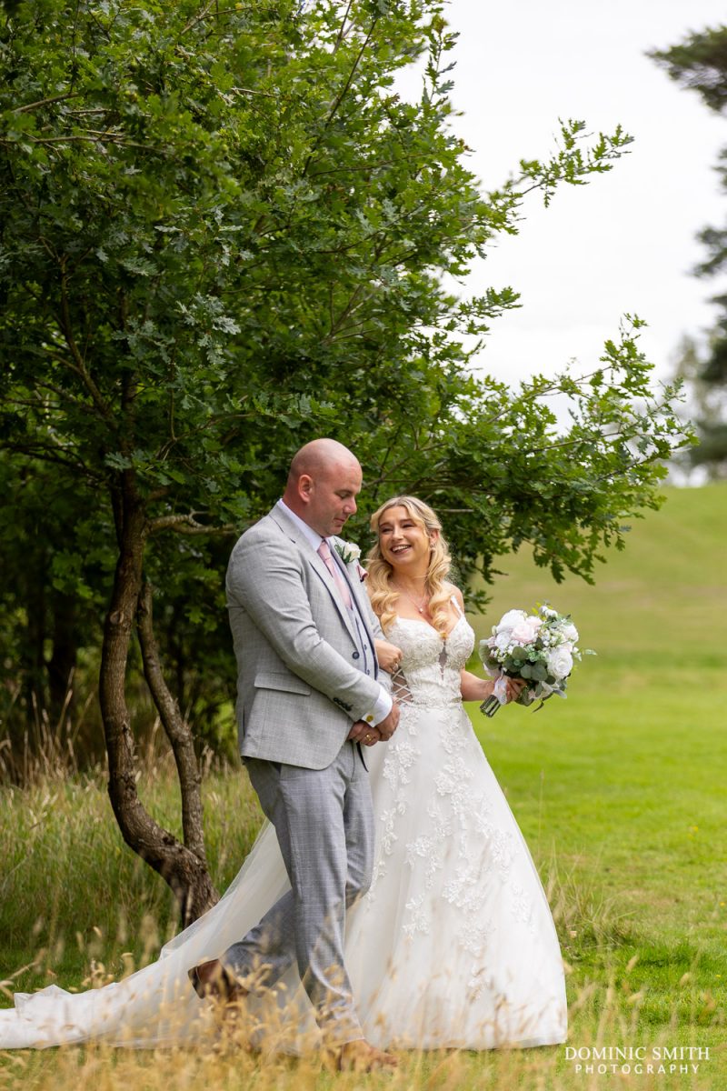 Bride and Groom walking outside Cottesmore Golf Club