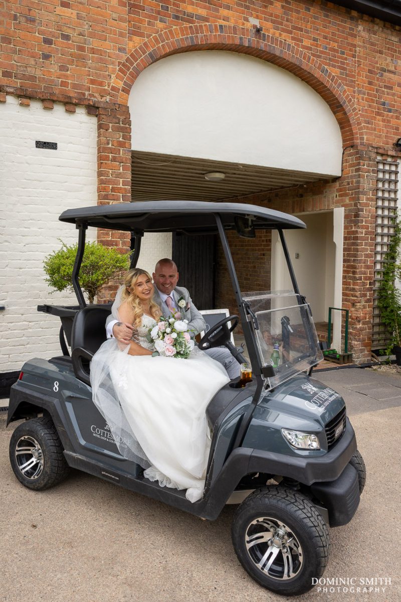 Bride and Groom prepare to drive the golf buggies