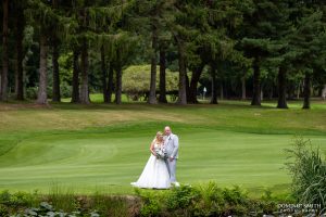Bride and Groom by the lake at Cottesmore