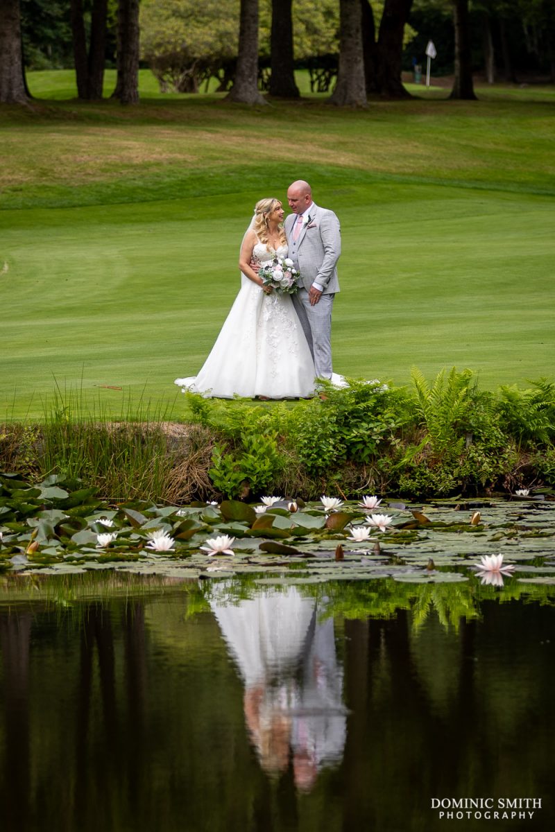 Bride and Groom with clear reflection on Cottesmore Golf Club