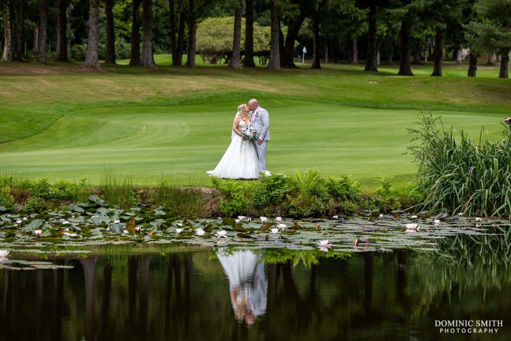 Bride and Groom Kiss on Cottesmore Golf Course