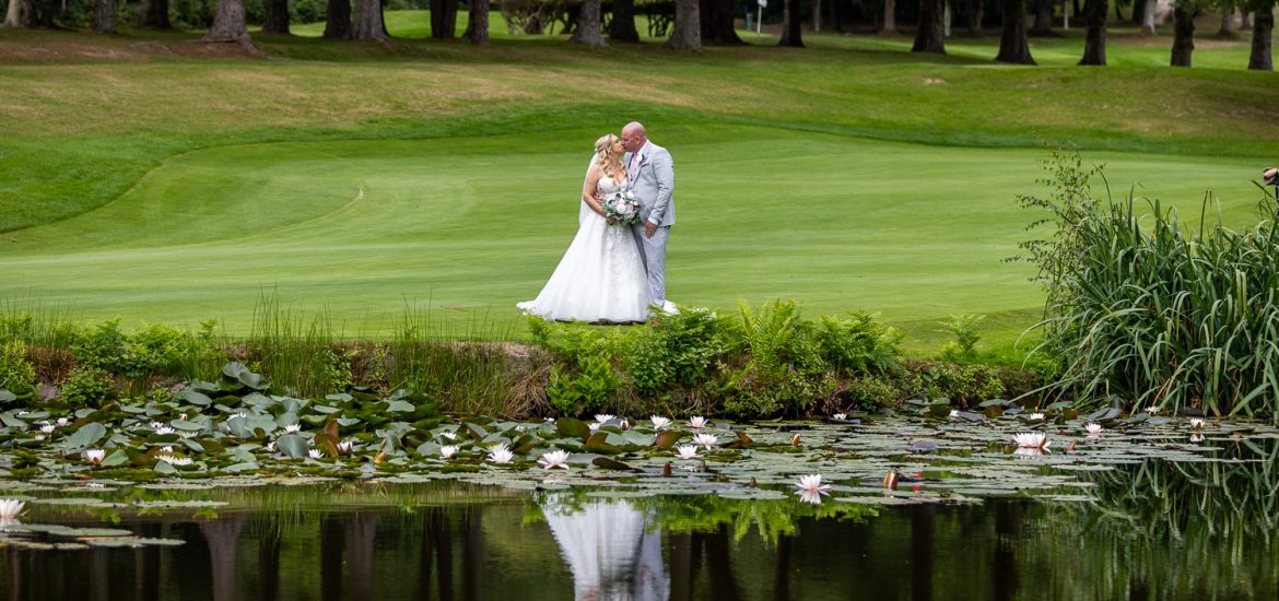 Bride and Groom Kiss on Cottesmore Golf Course