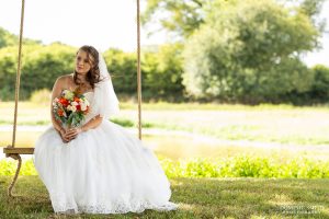 Bride sitting on the Southlands Barn swing