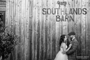 Black and White Wedding Couple Photo in front of the Southlands Barn sign