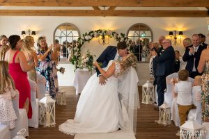 Sweetheart kiss when coming down the aisle at Cottesmore Golf Club