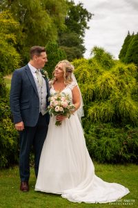 Bride and Groom pose for a photo at Cottesmore Golf Club