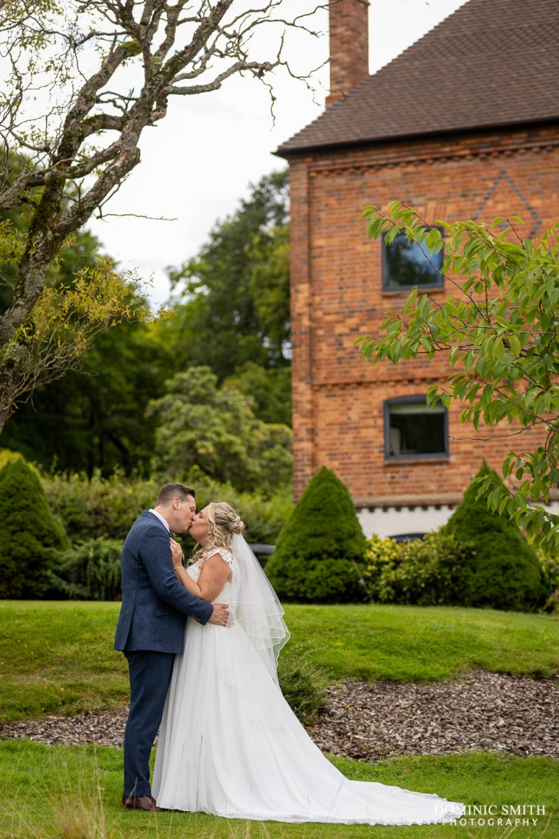 Wedding couple share a kiss at Cottesmore Golf Club