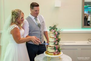 Cutting the wedding cake at Cottesmore Golf Club
