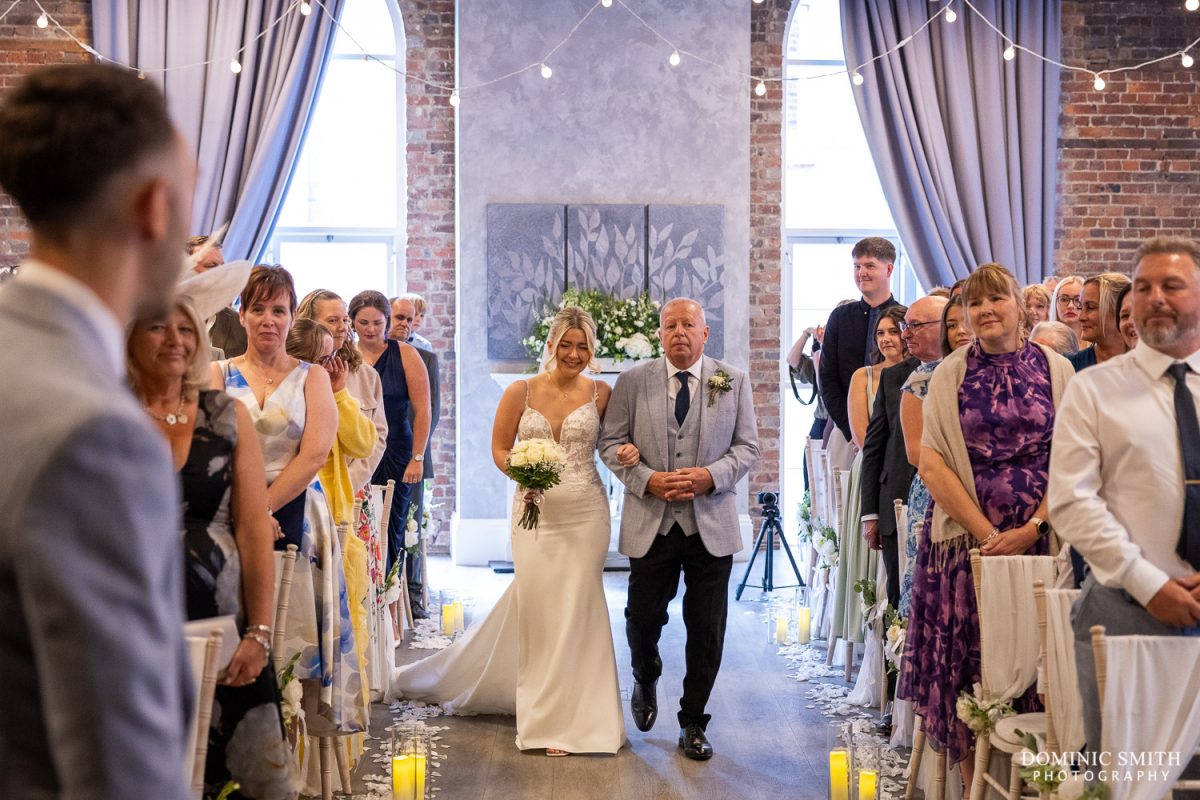 Bride walking down the aisle at One Warwick Park Hotel