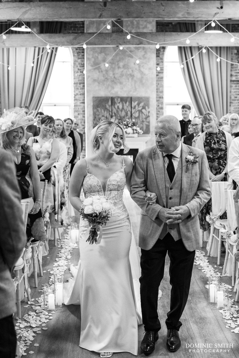 Black and white photo of the bride and her father walking down the aisle at One Warwick Park Hotel