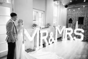 Bride and Groom with Mr and Mrs sign at One Warwick Park Hotel