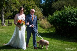Bride being escorted down the aisle at Millwards Estate