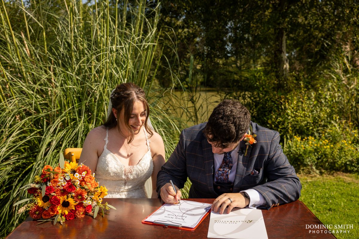 Signing the wedding register at Millwards Estate, Sussex