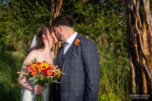 Bride and Groom share a kiss at Millwards Estate