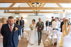 Bride is escorted by her brother to her ceremony
