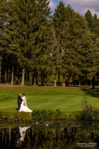 Bride and Groom at the lake at Cottesmore Golf Club