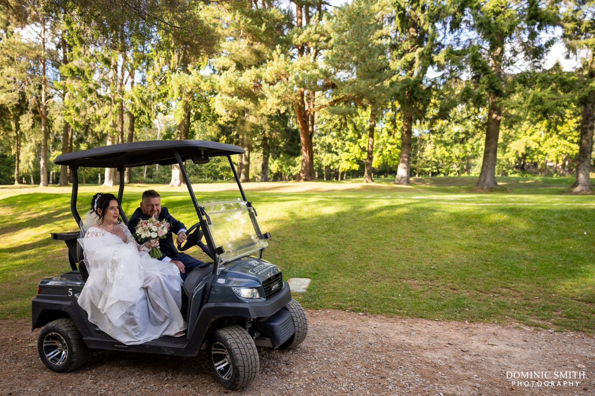 Bride and Groom driving the golf buggies at Cottesmore