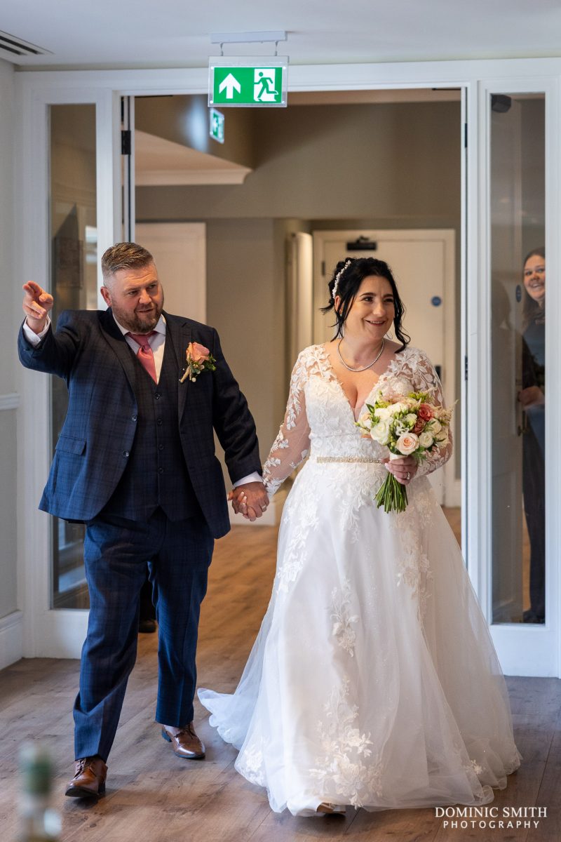 Bride and Groom entering their reception at Cottesmore Golf Club