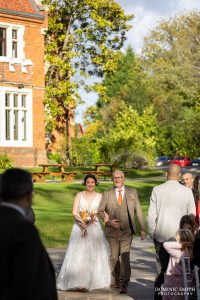 Bride being escorted down the aisle at Highley Manor
