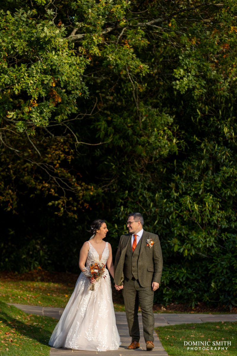 Bride and Groom walking through the grounds at Highley Manor