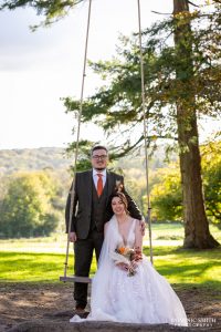 Bride and Groom sitting on the swing at Highley Manor