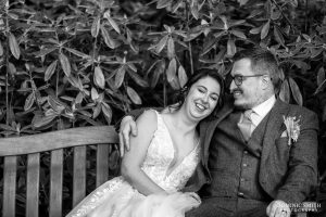 Bride and Groom sitting on a bench