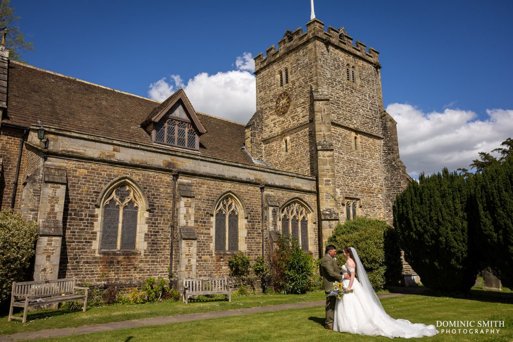 Bride and Groom with St Margarets Church in Horsham