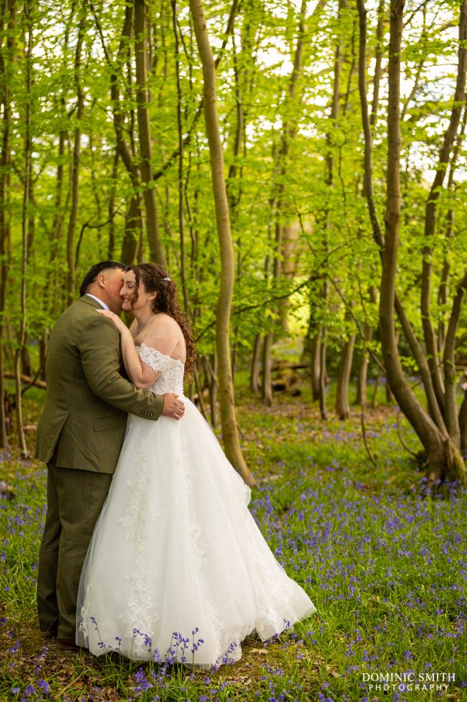 Bride and Groom kiss in the Gildings Barns Bluebells