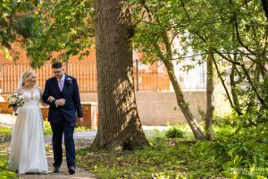 Bride and Groom walking through the Stanhill Court Grounds