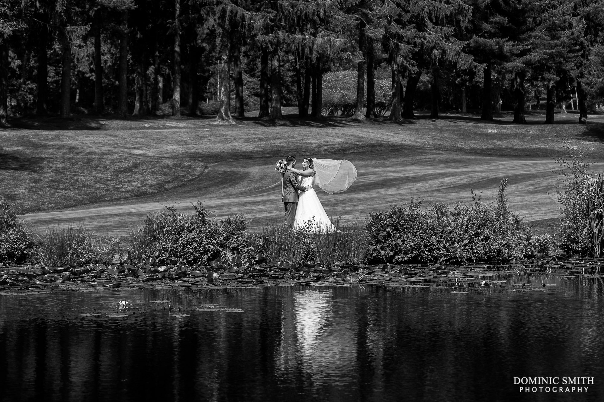 Black and White Portrait of the Bride and Groom at the Cottesmore Golf Club Lake