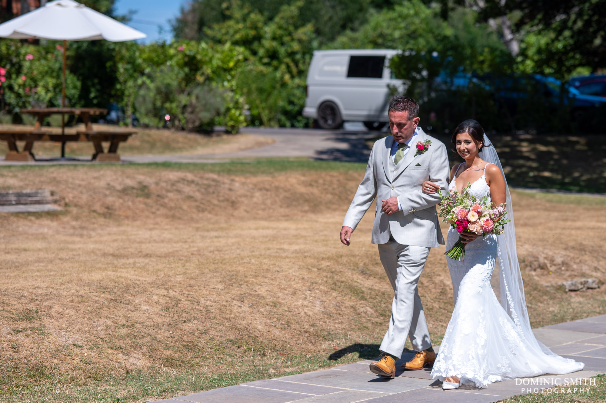 Bride being escorted to her ceremony at Highley Manor