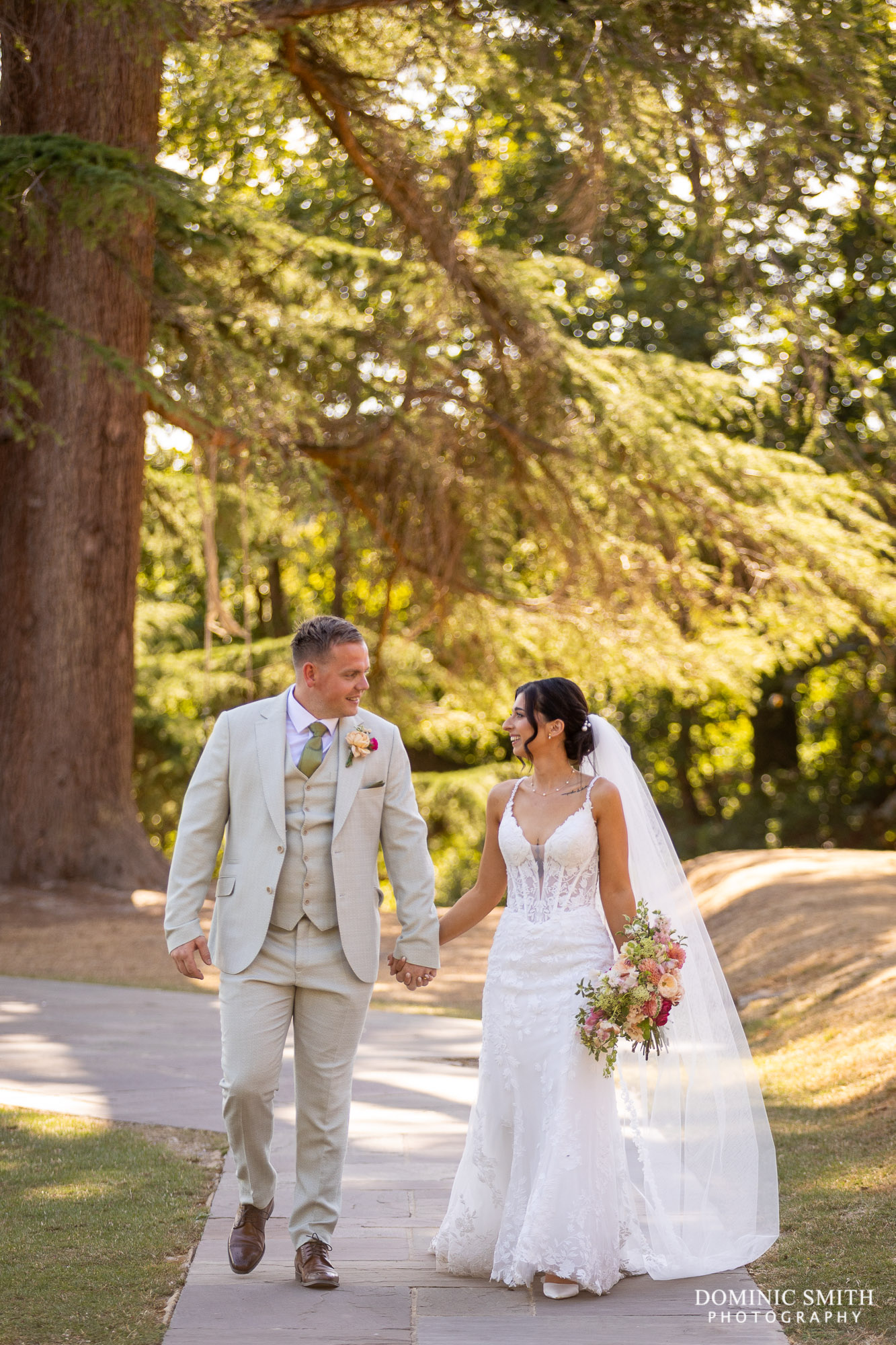 Bride and Groom walking outside Highley Manor
